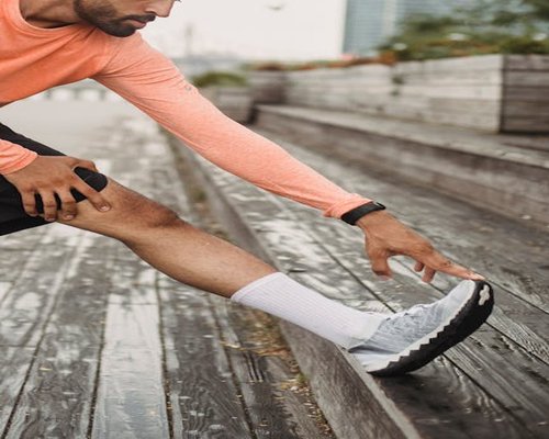 Adult person performing gentle morning stretch outdoors